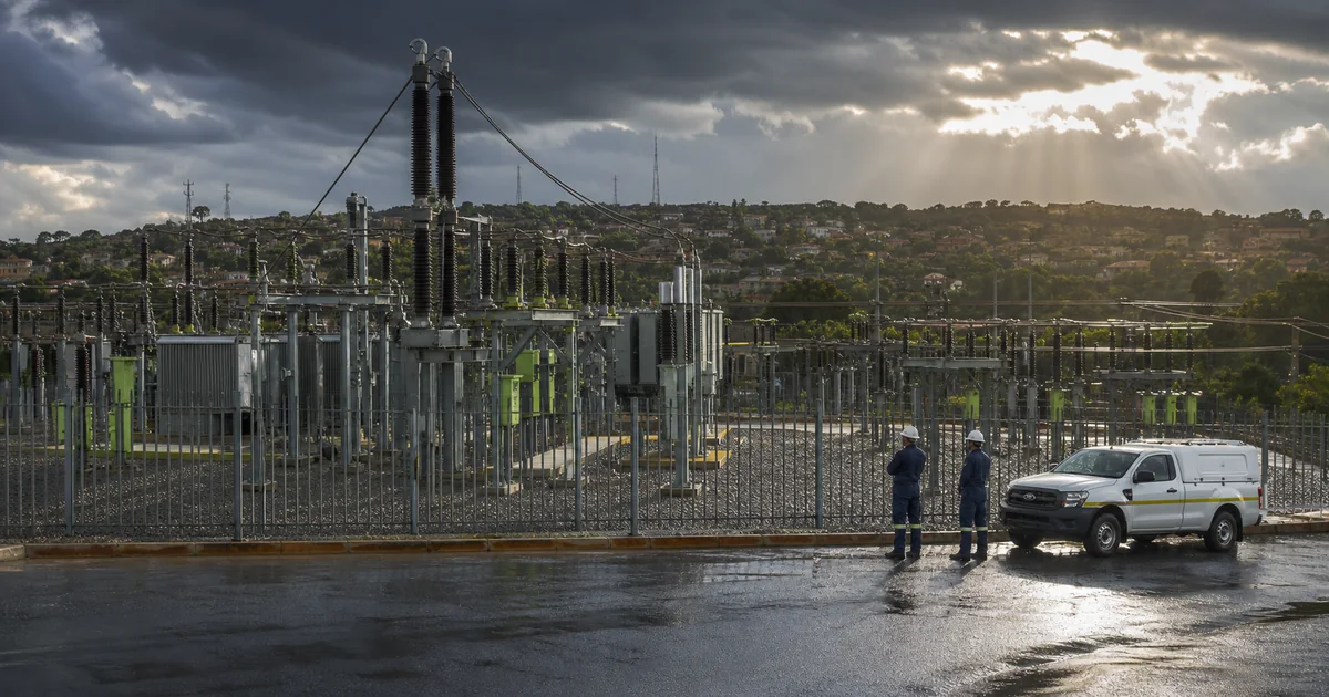 Electrical substation serving Roodepoort suburbs after a storm with technical crews working safely outside the fenced site